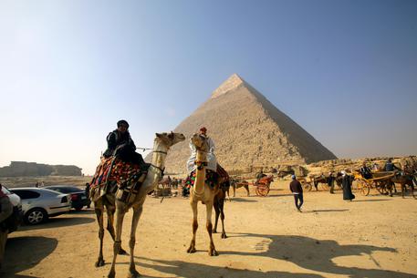 Tourists visit the Pyramids of Giza